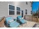 Relaxing back deck featuring cozy seating and a charming side table, perfect for enjoying the outdoors at 90 Rigsby Ave, Four Oaks, NC 27524