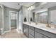 Modern bathroom with dual sinks, white countertops, and a walk-in glass shower at 90 Rigsby Ave, Four Oaks, NC 27524