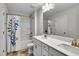 Well-lit bathroom featuring a double vanity, white cabinets, and a shower-tub combo with a stylish curtain at 90 Rigsby Ave, Four Oaks, NC 27524