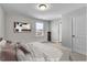 Cozy bedroom with neutral tones, featuring a comfortable bed and ample natural light creating a relaxing atmosphere at 90 Rigsby Ave, Four Oaks, NC 27524