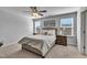 Well-lit bedroom with windows, plush bedding, bedside tables, and lamps for relaxation and rest at 90 Rigsby Ave, Four Oaks, NC 27524