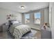 Charming bedroom with two windows, decor, and bedding creating a cozy and inviting space at 90 Rigsby Ave, Four Oaks, NC 27524