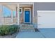 Inviting covered front porch and blue front door enhance the curb appeal of the home at 90 Rigsby Ave, Four Oaks, NC 27524