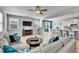 Sun-filled living room seamlessly connects to the dining area and a well-equipped kitchen with a modern ceiling fan at 90 Rigsby Ave, Four Oaks, NC 27524