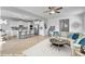 Spacious living room is open to the kitchen featuring stainless appliances and a breakfast bar with pendant lighting at 90 Rigsby Ave, Four Oaks, NC 27524