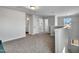 Upstairs loft area with neutral carpet, natural light, and access to bedrooms and bathrooms at 90 Rigsby Ave, Four Oaks, NC 27524
