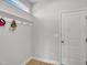 Mud room with coat hooks, access to garage, and durable flooring for easy cleanup after outdoor adventures at 90 Rigsby Ave, Four Oaks, NC 27524
