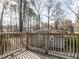Inviting back porch featuring wooden slats and serene views of a wooded landscape at 916 Belhaven Rd, Cary, NC 27513