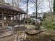 Backyard featuring stone pathway, garden, storage shed, and screened-in porch at 916 Belhaven Rd, Cary, NC 27513