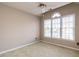 Neutral bedroom featuring a ceiling fan and a large window at 916 Belhaven Rd, Cary, NC 27513