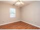 Neutral bedroom featuring a ceiling fan and a large window at 916 Belhaven Rd, Cary, NC 27513