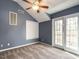 Upstairs bedroom offers plush carpets, modern ceiling fan and doors to an outdoor porch at 916 Belhaven Rd, Cary, NC 27513