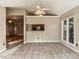 Bright dining area with tile flooring, a ceiling fan, and views to other rooms at 916 Belhaven Rd, Cary, NC 27513