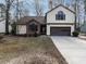 Charming two-story home with tan siding, a brick facade, and a two-car garage at 916 Belhaven Rd, Cary, NC 27513