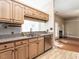 Well-lit kitchen with stainless steel dishwasher, granite counters, and light-colored cabinets at 916 Belhaven Rd, Cary, NC 27513