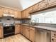 Traditional kitchen featuring light wood cabinets, granite counters, and stainless steel dishwasher at 916 Belhaven Rd, Cary, NC 27513