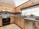 Well-lit kitchen with stainless steel appliances, wood cabinetry, and granite countertops at 916 Belhaven Rd, Cary, NC 27513