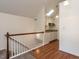 Upstairs kitchenette featuring wood floors, crisp white cabinets, and skylight at 916 Belhaven Rd, Cary, NC 27513