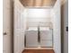 Laundry closet featuring a white washer and dryer with wire shelving at 916 Belhaven Rd, Cary, NC 27513