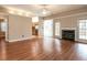 Spacious living room with hardwood floors, fireplace, and natural light at 916 Belhaven Rd, Cary, NC 27513