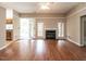 Open living room featuring hardwood floors, a fireplace, and neutral decor at 916 Belhaven Rd, Cary, NC 27513