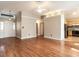 Open-concept living room with hardwood floors, access to entryway and kitchen at 916 Belhaven Rd, Cary, NC 27513