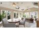 Beautiful staged sunroom featuring a round table, plants and furniture at 916 Belhaven Rd, Cary, NC 27513