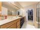 Bathroom features a double vanity, large mirror, and access to a well-organized walk-in closet at 9211 Calabria Dr # 117, Raleigh, NC 27617