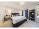 Comfortable bedroom features neutral tones, a ceiling fan, and a large window with natural light at 9211 Calabria Dr # 117, Raleigh, NC 27617