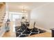 Elegant dining room with stylish table set and attractive black and white patterned rug at 9211 Calabria Dr # 117, Raleigh, NC 27617