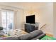 Comfortable living room with hardwood floors, a modern entertainment center, and access to an outdoor space at 9211 Calabria Dr # 117, Raleigh, NC 27617