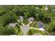 This aerial shot showcases the home's placement in a wooded lot within a serene, upscale neighborhood at 946 Berry Patch Ln, Pittsboro, NC 27312