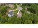An aerial view shows the property nestled among lush trees in a quiet cul-de-sac, highlighting its private location at 946 Berry Patch Ln, Pittsboro, NC 27312