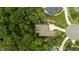 This overhead aerial view reveals the home's architectural design, large lot, and surrounding lush greenery at 946 Berry Patch Ln, Pittsboro, NC 27312