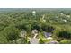 This aerial view shows the property's location in a lush, green neighborhood with mature trees and manicured lawns at 946 Berry Patch Ln, Pittsboro, NC 27312