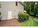 The backyard shows a door leading to the basement and a well-manicured lawn with professional landscaping at 946 Berry Patch Ln, Pittsboro, NC 27312