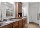 Bathroom featuring double sinks, granite countertops, and elegant wood cabinetry at 946 Berry Patch Ln, Pittsboro, NC 27312