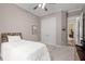 This carpeted bedroom has a ceiling fan and a pair of full-sized closets at 946 Berry Patch Ln, Pittsboro, NC 27312