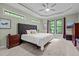 Comfortable bedroom boasts large windows, a tray ceiling, and a well-lit space with plush carpeting at 946 Berry Patch Ln, Pittsboro, NC 27312