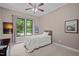 Cozy bedroom with neutral walls, carpeted floor, and natural light from the window overlooking the backyard at 946 Berry Patch Ln, Pittsboro, NC 27312