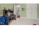 This green carpeted bedroom features a writing desk and natural light coming in through the doorway at 946 Berry Patch Ln, Pittsboro, NC 27312