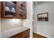 Elegant butler's pantry featuring granite countertops, glass-front cabinets, and ample storage at 946 Berry Patch Ln, Pittsboro, NC 27312