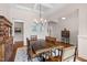 Elegant dining room with coffered ceiling, chandelier, and a wooden table set at 946 Berry Patch Ln, Pittsboro, NC 27312