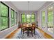 Bright dining room featuring hardwood floors, natural light, and a square wooden table with four chairs at 946 Berry Patch Ln, Pittsboro, NC 27312