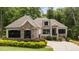 Charming home featuring stone accents, neutral siding, black shutters, and a well-manicured lawn at 946 Berry Patch Ln, Pittsboro, NC 27312