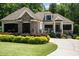 Home exterior with stone accents, well-manicured lawn, and front-facing garage at 946 Berry Patch Ln, Pittsboro, NC 27312