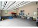 Spacious garage with epoxy floor, storage racks, and a door to the outside at 946 Berry Patch Ln, Pittsboro, NC 27312