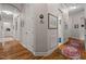 Well-lit hallway features hardwood floors, white trim, and stylish decor at 946 Berry Patch Ln, Pittsboro, NC 27312