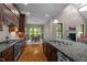 Spacious kitchen featuring granite countertops, stainless appliances, hardwood floors, and an eat-in area at 946 Berry Patch Ln, Pittsboro, NC 27312