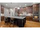 Modern kitchen with stainless appliances, granite countertops, island, and dark wood cabinets at 946 Berry Patch Ln, Pittsboro, NC 27312